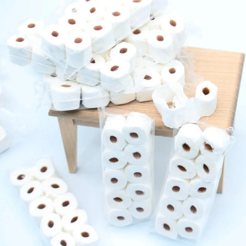 Miniature paper simulated tissue roll model for dollhouse play, measuring 30mm by 15mm by 80mm.