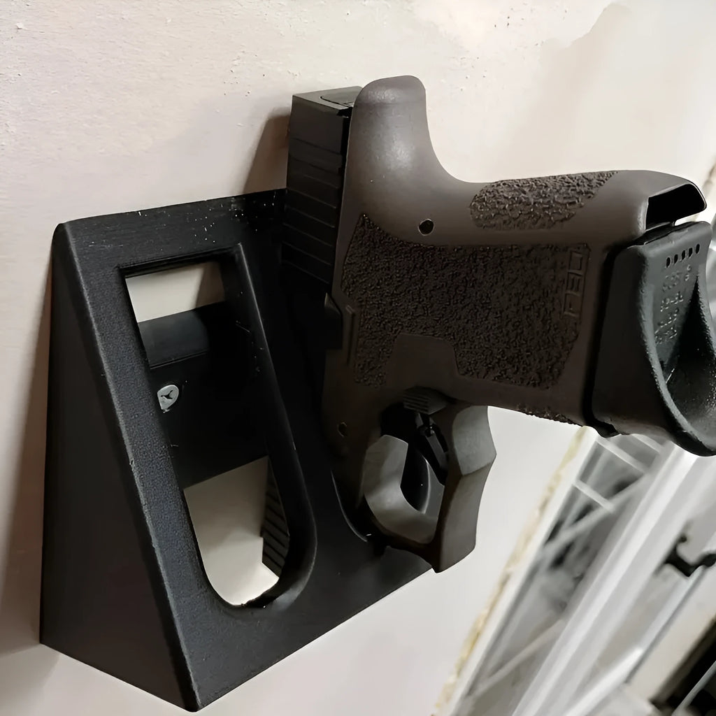 Black plastic pistol stand gun holder measuring 10.85cm x 7.6cm for displaying replica firearms