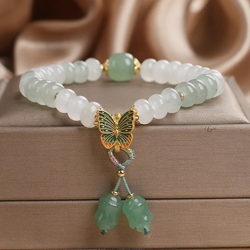Green crystal women's bracelet with abacus beads, butterfly charm and tassel showing 17cm adjustable purity