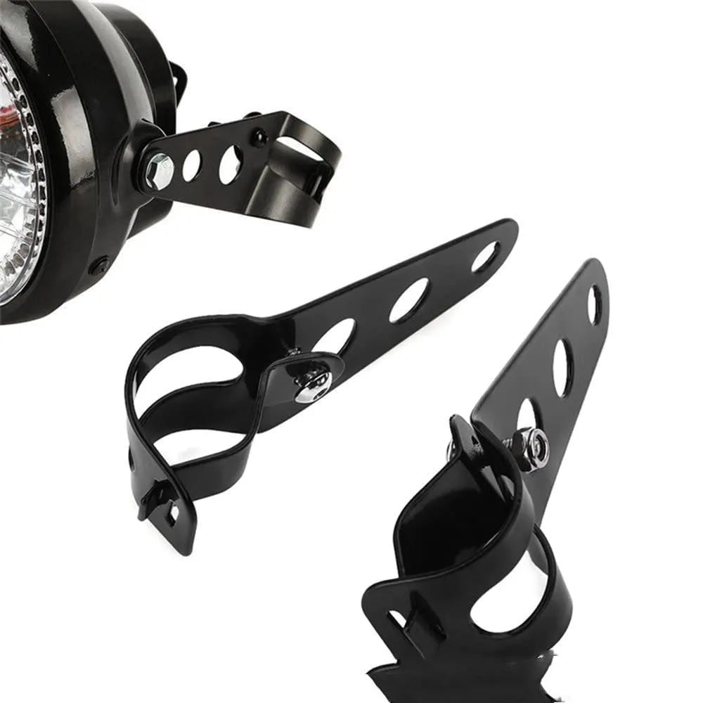 A pair of black iron motorcycle headlamp support brackets for retro bike modification.