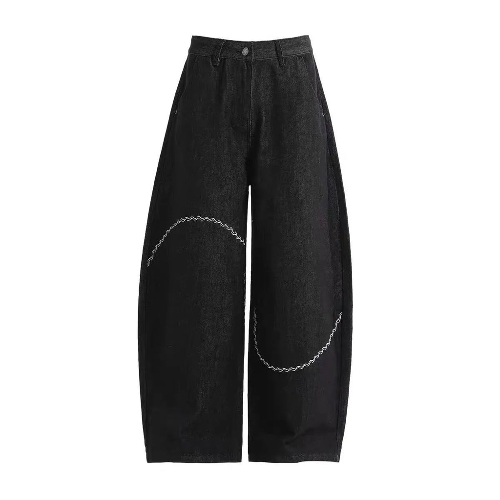 Black straight-leg denim trousers with micro-elastic fabric and mid-waist zip fly