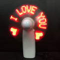 White handheld flashing fan showing LED love pattern in blue and red colours