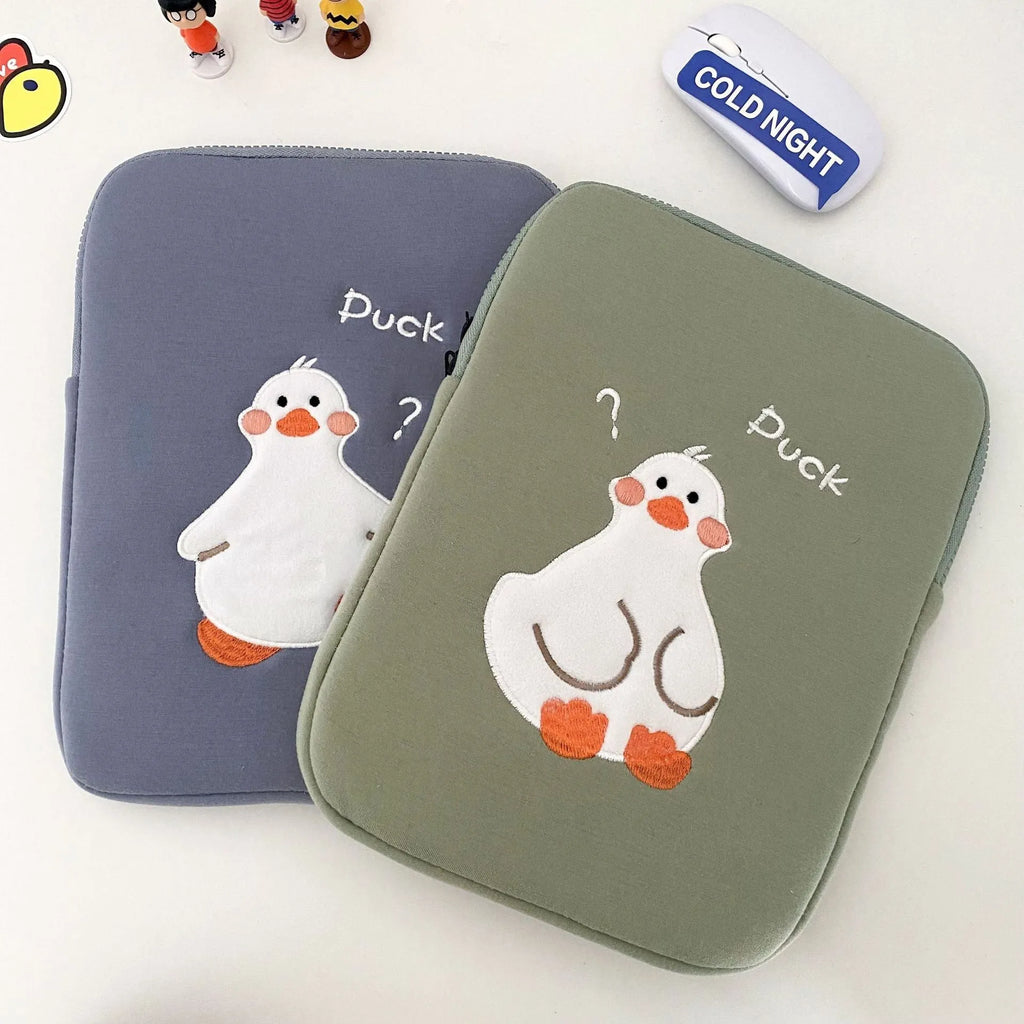 Blue cotton tablet case with embroidered cartoon duck design and a zipper, shown next to a green version.