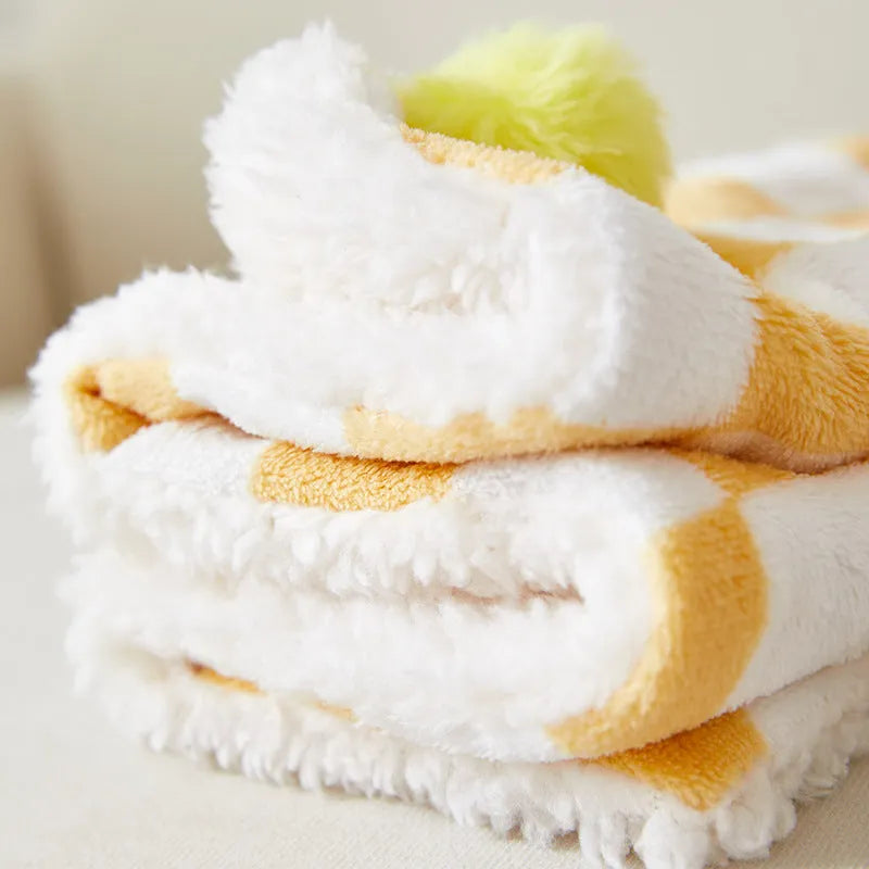 Plaid pattern pet blanket with fur ball decoration in green, pink, or yellow colours on soft fleece material