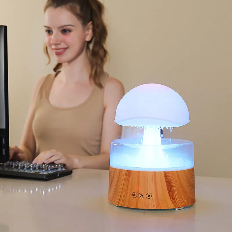 White cloud-shaped humidifier with LED lights and simulated rainfall, includes remote control