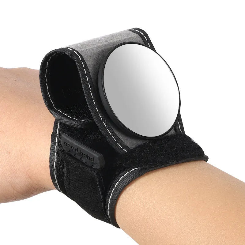 Black bicycle rear-view mirror mounted on an adjustable nylon wrist strap for cycling.