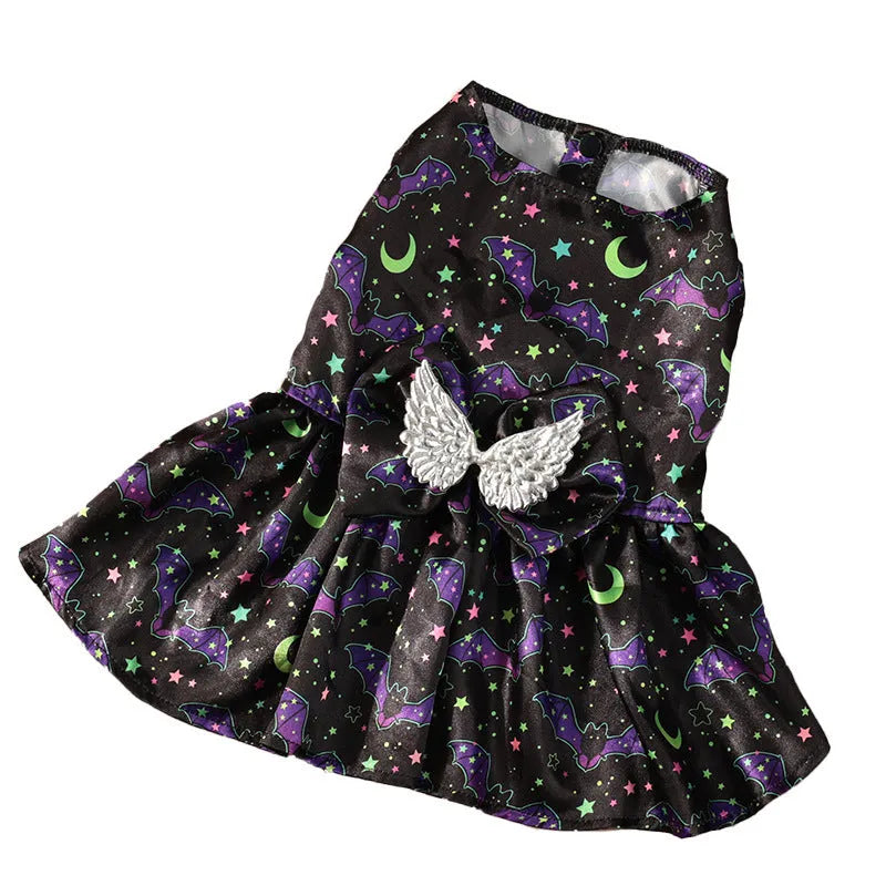 Dog wearing an angel wings Halloween costume in bright orange or purple colours