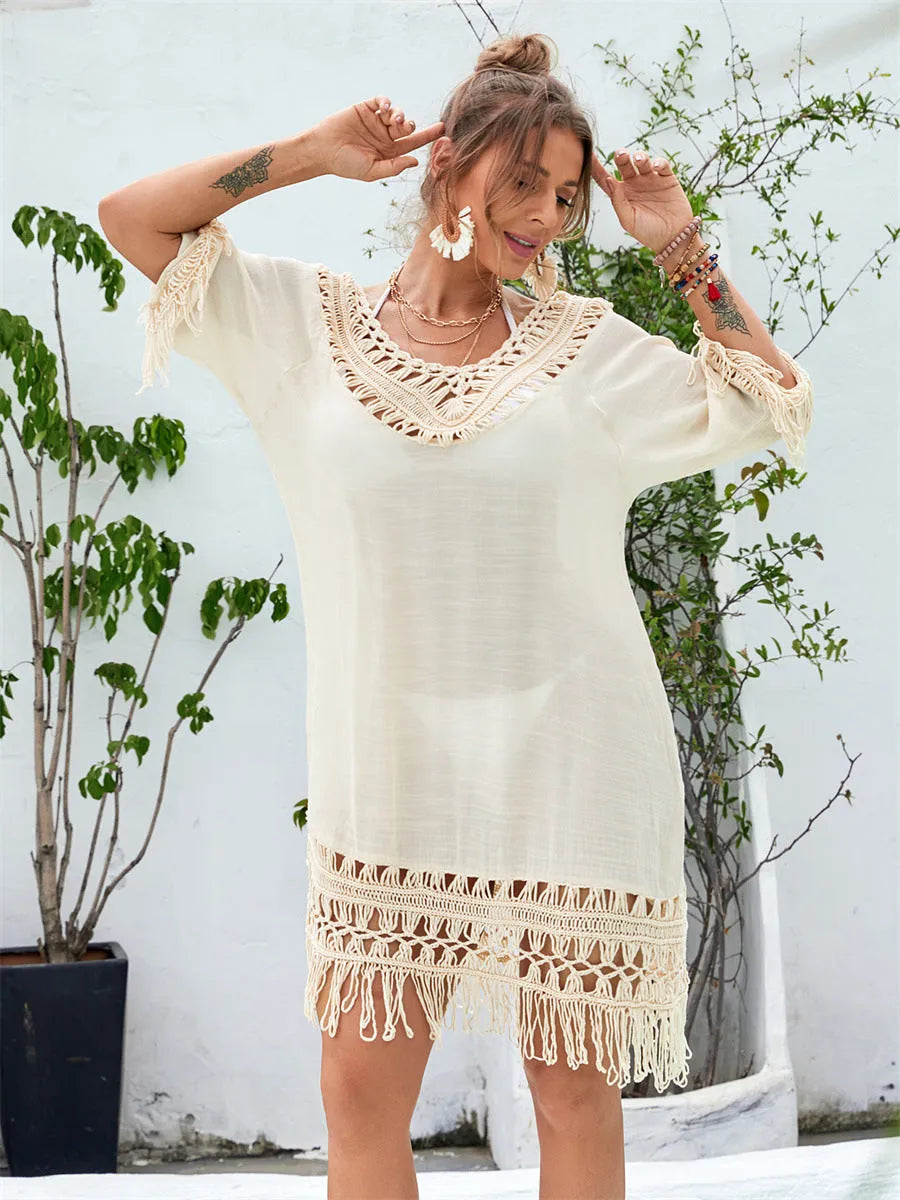 Women's apricot hand-crocheted beach dress with polyester lining shown on hanger