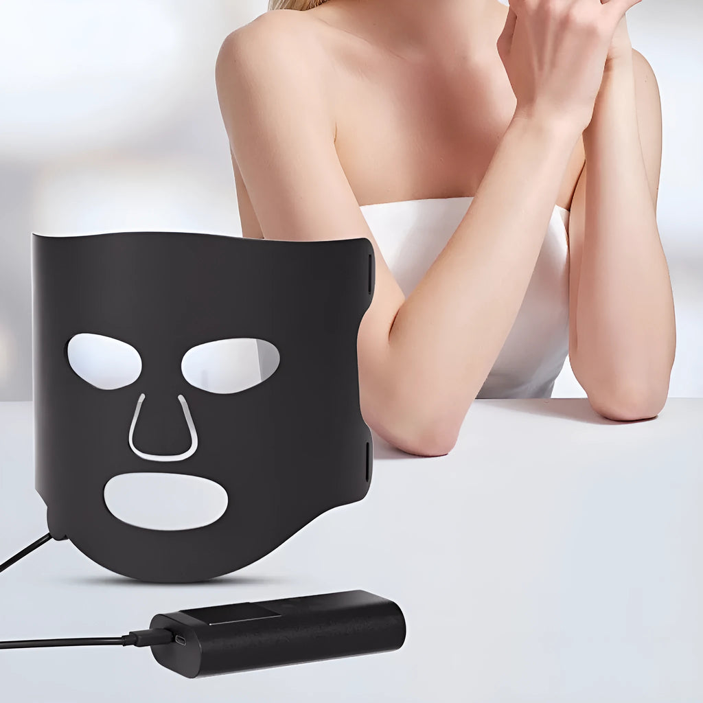 Black and white LED phototherapy face mask with controller for home skin light therapy treatment.