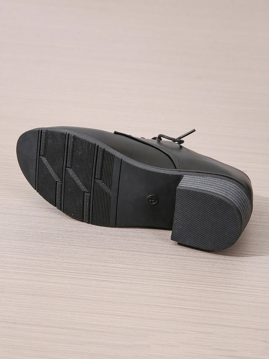 Black women's lace-up work shoes with a thick chunky heel and soft rubber sole.