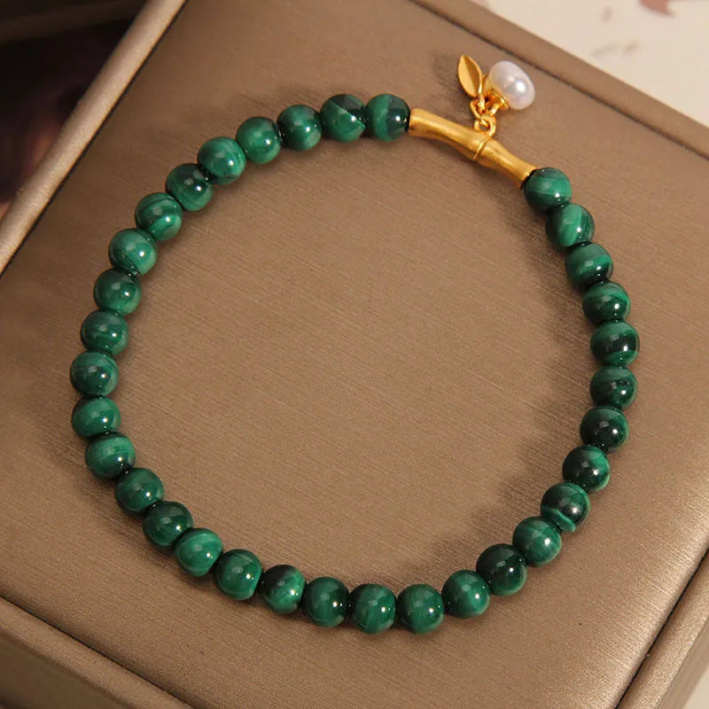 Women's white crystal bracelet with a raised lucky bamboo design centrepiece.