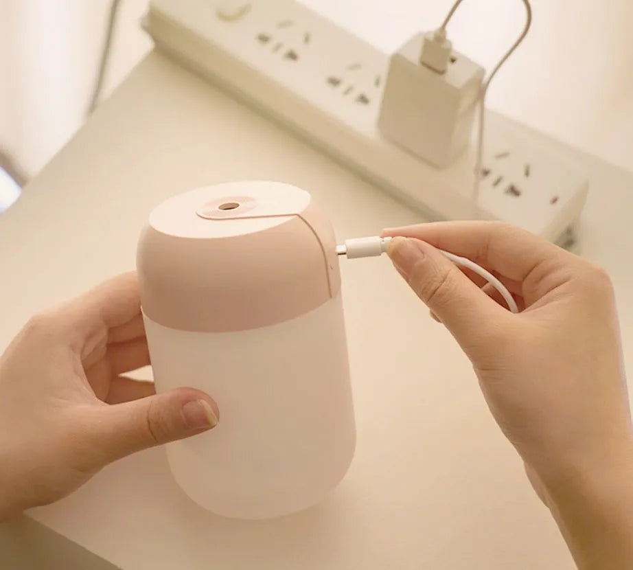 White cylindrical mini humidifier with USB cable for portable operation in small rooms