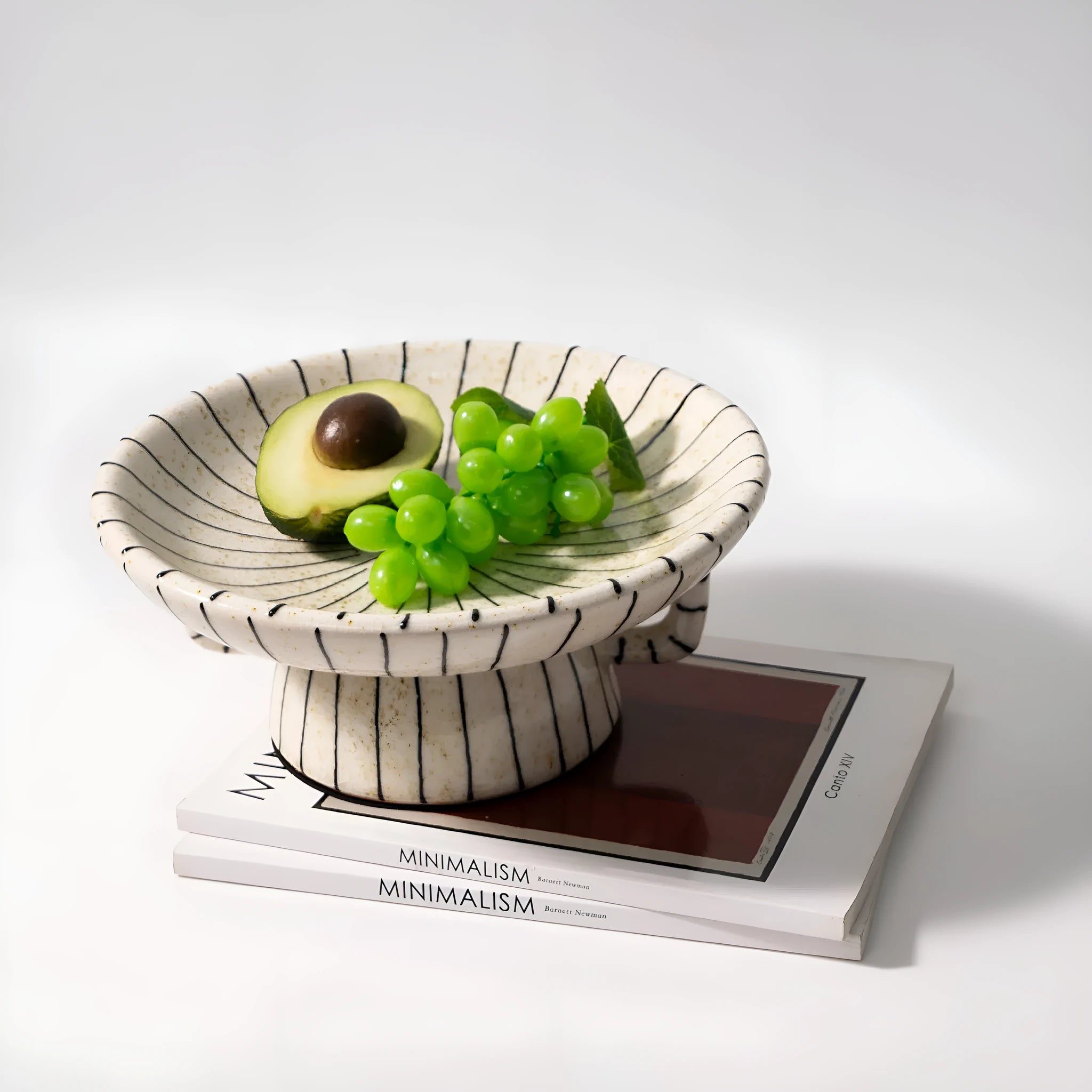 Black and white striped plastic resin dessert plate on a table.