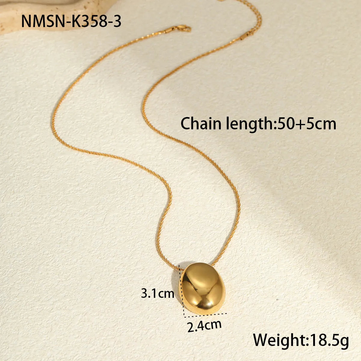 Gold geometric pendant necklace on adjustable chain against white background