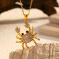 Gold electroplated stainless steel crab pendant necklace with diamond accents on regular chain, natural style