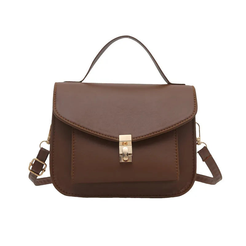Retro style square messenger bag in PU with a crossbody strap and internal document pocket.