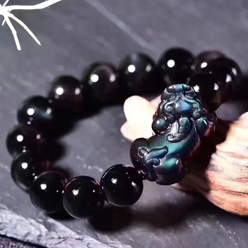 Natural ice colour eye obsidian crystal bracelet on a wrist, showing bead size options.