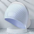 Silicone adult swimming cap in solid colour water drop design on white background.
