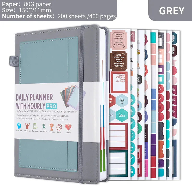 A6 self-filled notebook with PU cover in various colours, shown open on wooden table.