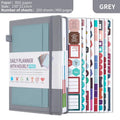 A6 self-filled notebook with PU cover in various colours, shown open on wooden table.