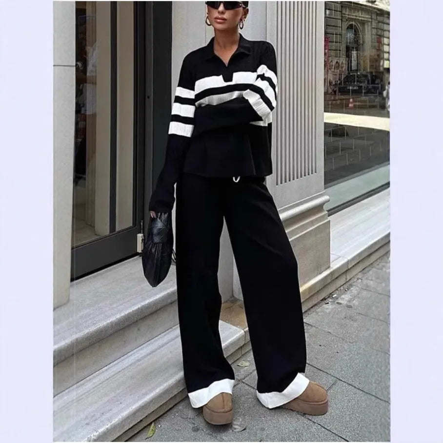 Women wearing black and white striped polo collar two-piece set with matching trousers
