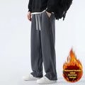 Men's apricot double-sided polar fleece-lined loose fit winter sports trousers on a hanger
