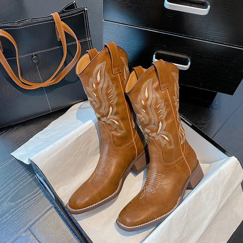 Brown women's embroidered mid-calf Martin boots with leather lining and a square heel.