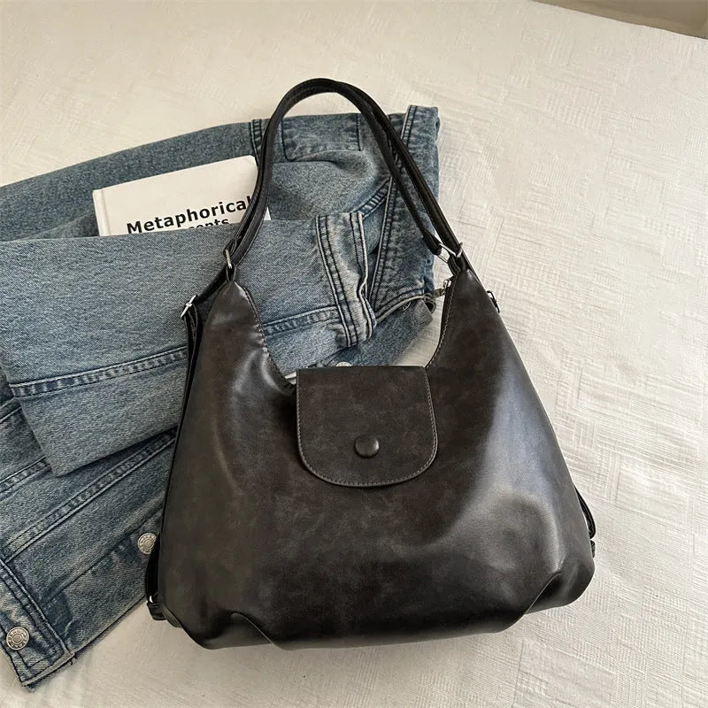 Textured PU leather shoulder bag in horizontal square shape with single strap and internal phone pocket