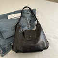 Textured PU leather shoulder bag in horizontal square shape with single strap and internal phone pocket