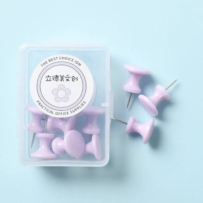 Box of plastic push pins in large and small sizes showing cherry blossom pink, mint green, and lavender colours.
