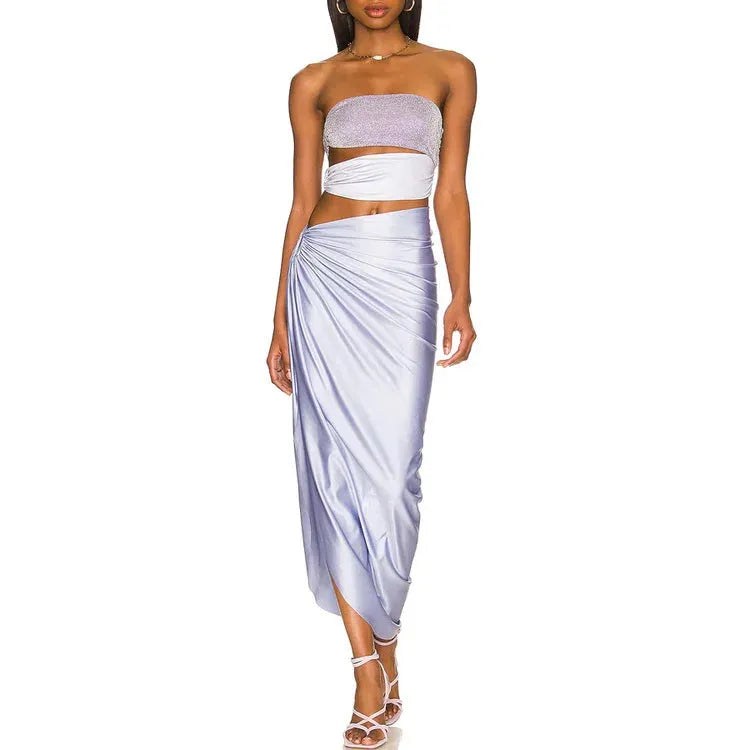 Purple women's one-piece swimsuit with matching wrap skirt on beach
