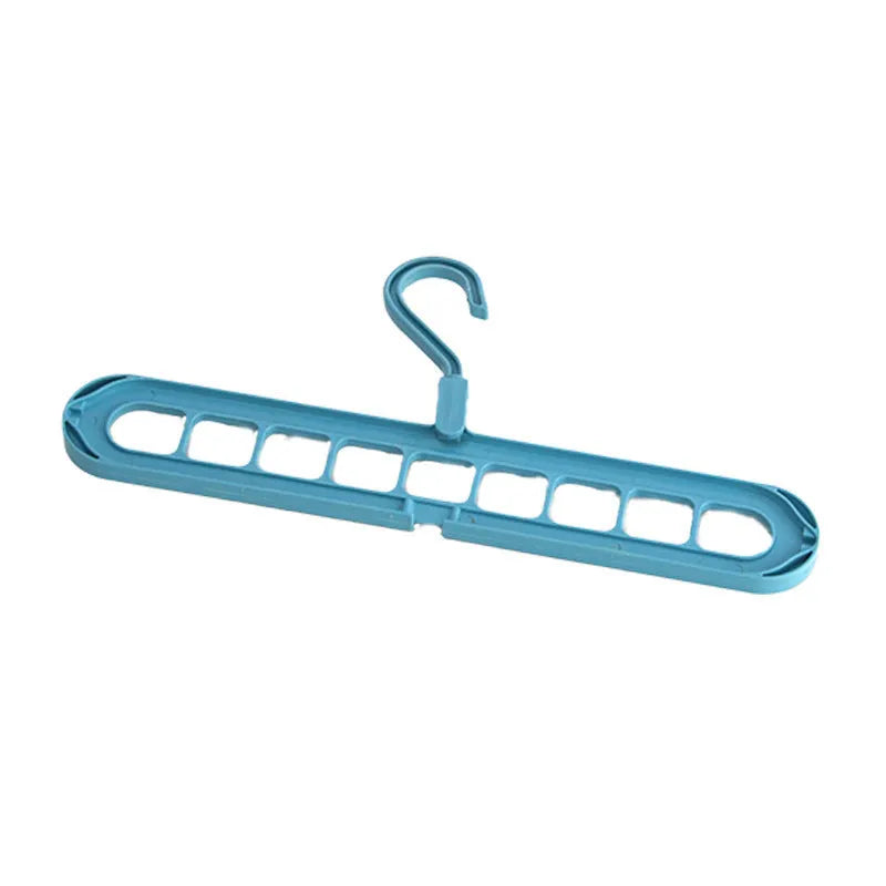 Green plastic nine-hole trousers hanger for wardrobe organisation with modern minimalist design