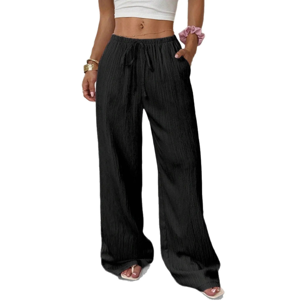 Women's black wide leg trousers with lace-up waist trimming showing adjustable detail