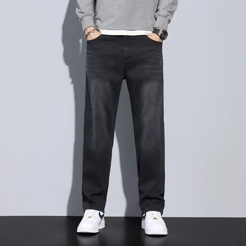 Men's straight leg casual jeans in black cotton denim with non-iron finish, side view.