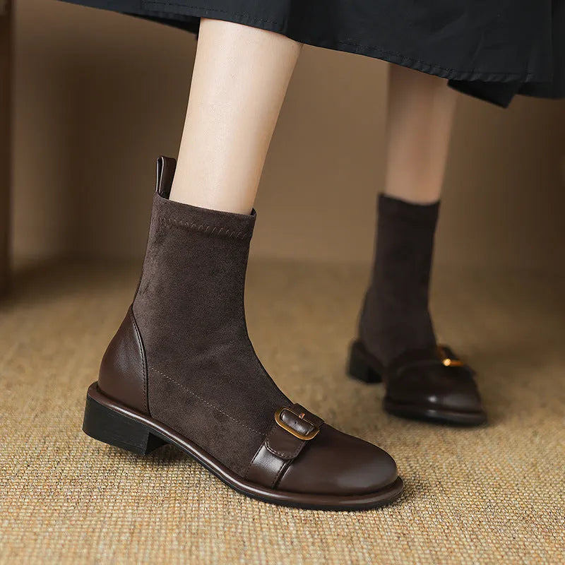 Women's black low heel Martin boots with round toe, belt buckle stitching, and lace-up front.