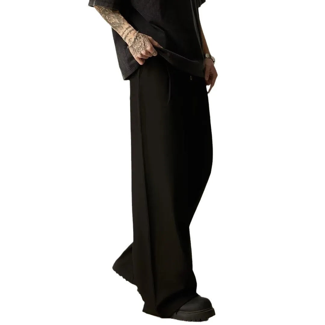 Man wearing black solid colour wide-leg casual trousers with a vertical tube design.