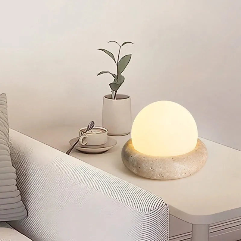 Cream coloured remote control bedside night lamp with yellow cave stone light on wooden table