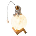 Gold resin astronaut figurine humidifier night light with wood base, 28 cm tall, on a desk