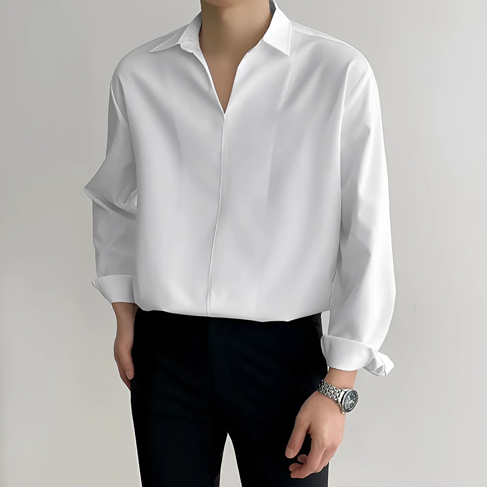 Man wearing a loose lapel, long sleeve casual shirt in a solid colour.