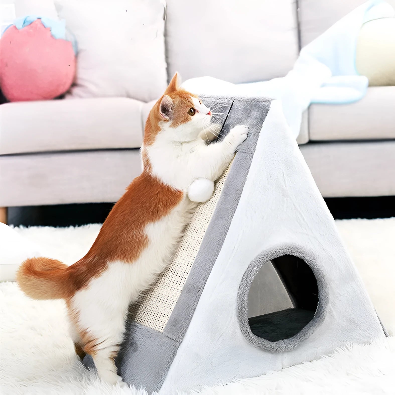 Grey and white triangular cat scratching post and bed with sisal fabric sides and a soft plush platform.