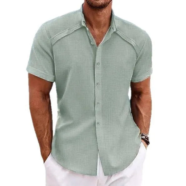 Man wearing a solid colour short sleeve Hawaiian casual shirt in a cotton blend fabric.