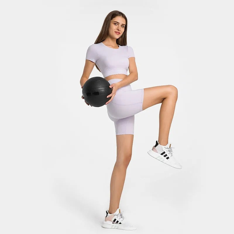 Women's tight-fitting mid-length sports shorts in a cotton blend fabric for running and fitness.