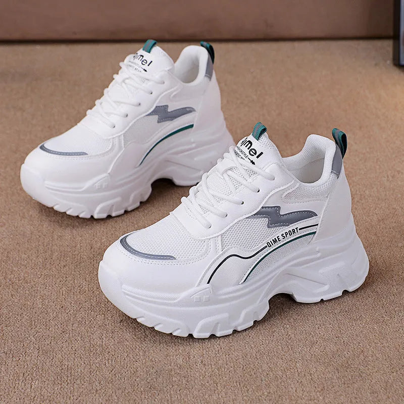 Women's white and beige low-top lace-up sports shoes with a breathable mesh upper.