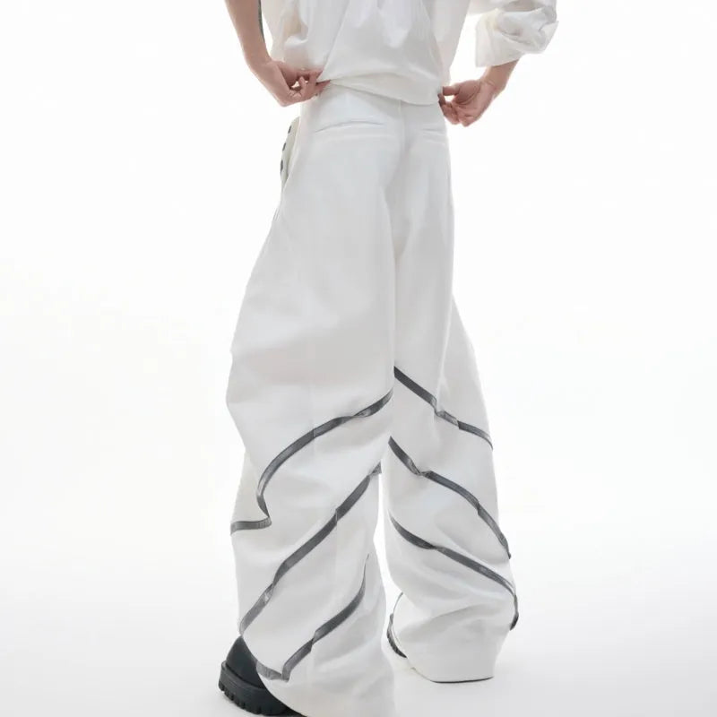 Men's polyester trousers with metal rivet accents and pleated detailing on three-dimensional cutting construction