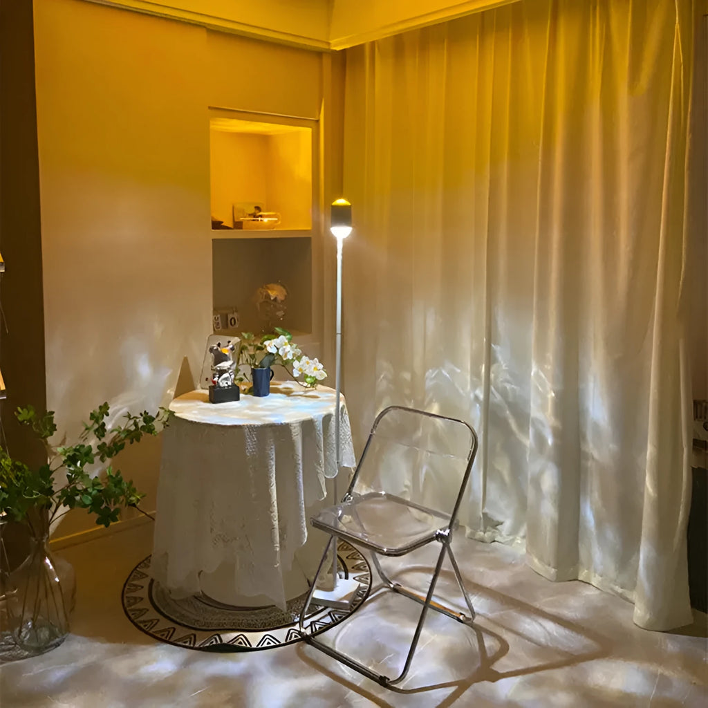 Sunset red floor lamp projecting a water wave light pattern onto a wall in a modern room.