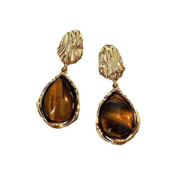 Three pairs of handmade geometric holiday earrings with tassel details in electroplated alloy