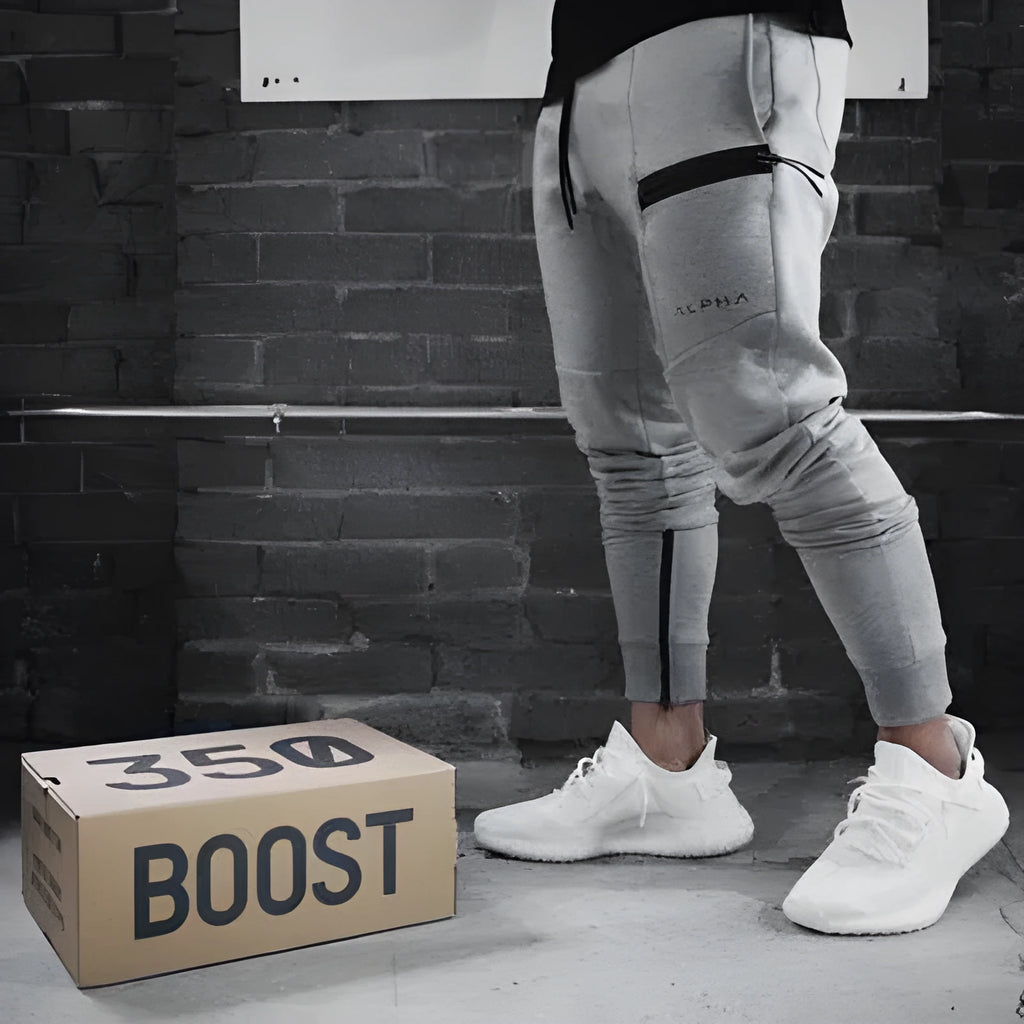 Men's black cotton joggers with elastic waist and velcro side pockets, loose fit, for sports and casual wear