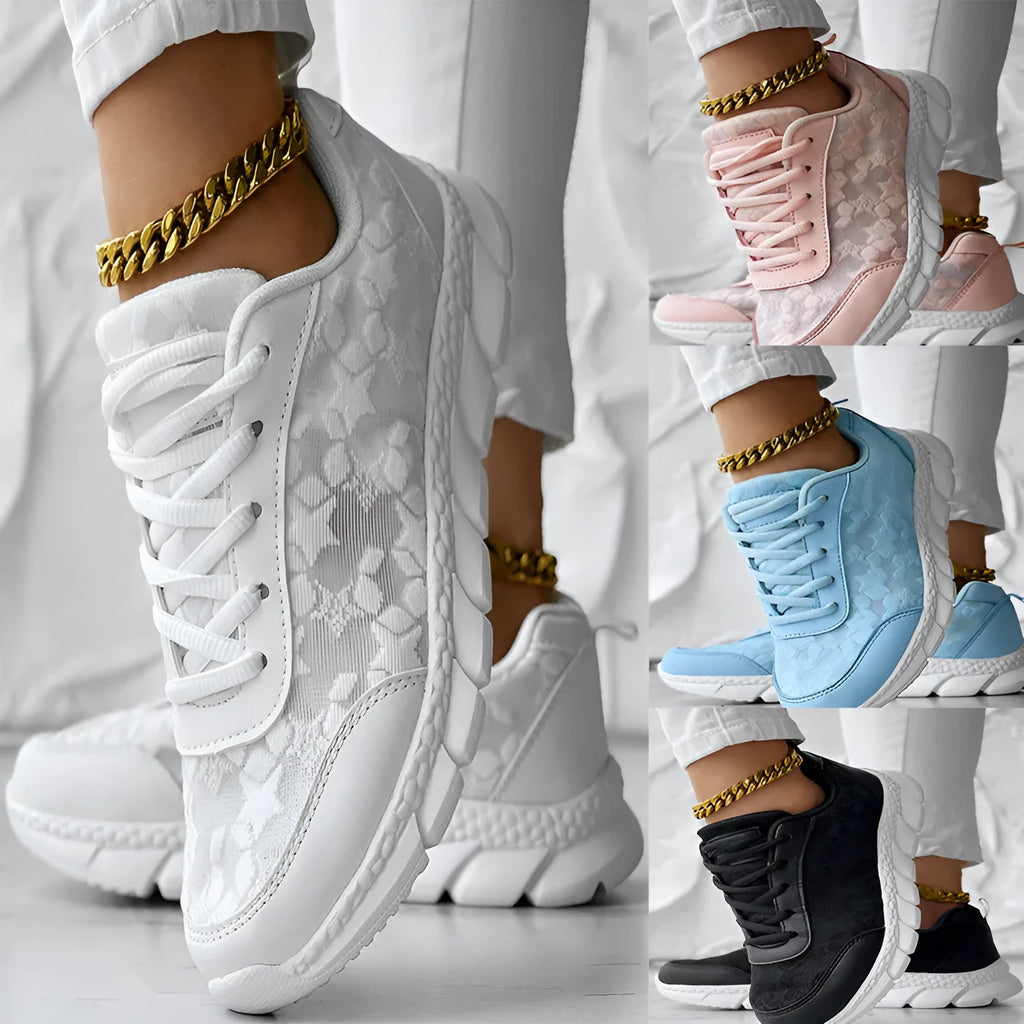 Women's white canvas running shoes with soft sole and round toe on a flat heel.