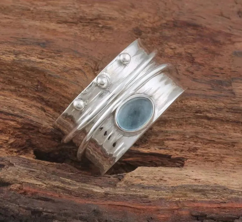 Handmade silver ring with natural aquamarine gemstone, retro geometric shape, on white background