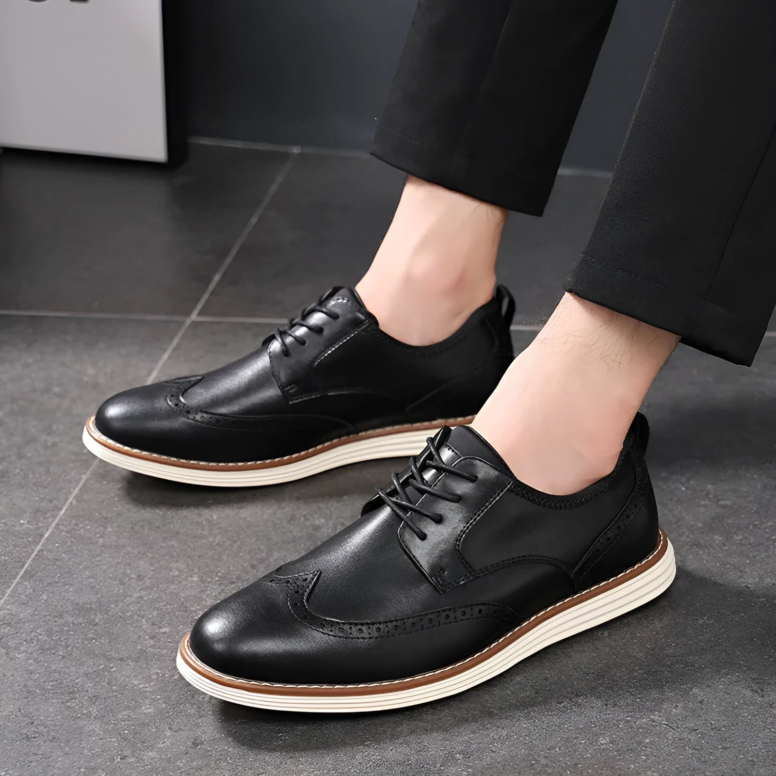 Men's black slip-on business casual shoe with round toe and carved PU upper detail on a TPR sole.
